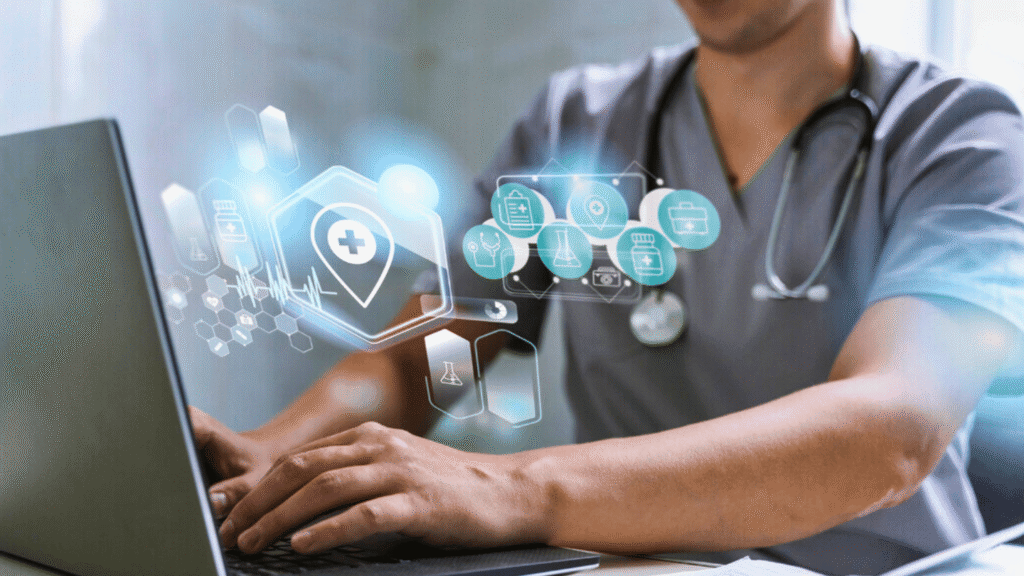 طبيب يعمل على حاسوب محمول يعرض أيقونات معلومات صحية رقمية، يمثل تطبيق التقنية في الرعاية كجزء من تخصص معلومات صحية.